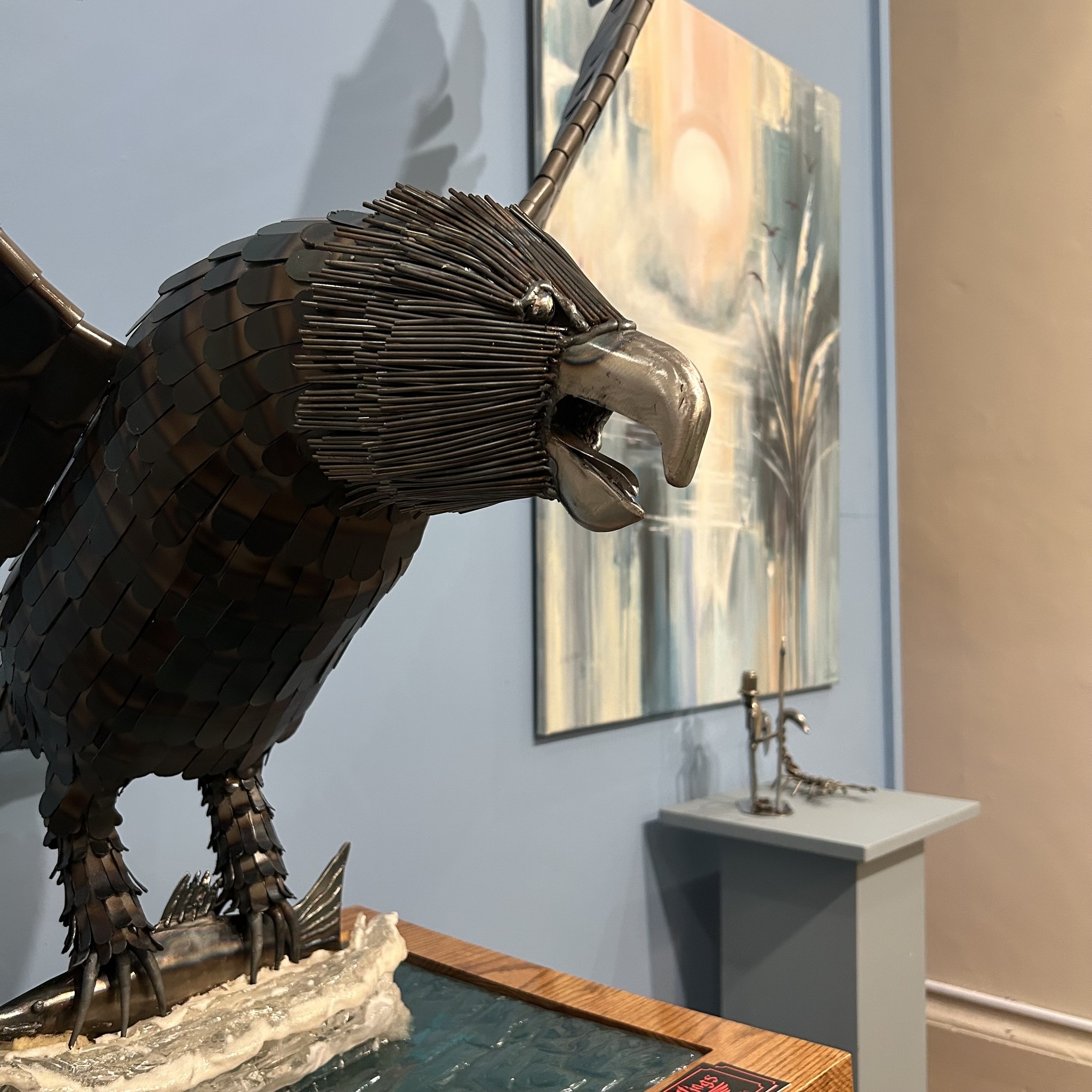 Close up of eagle sculpture and marine painting in Community Gallery.